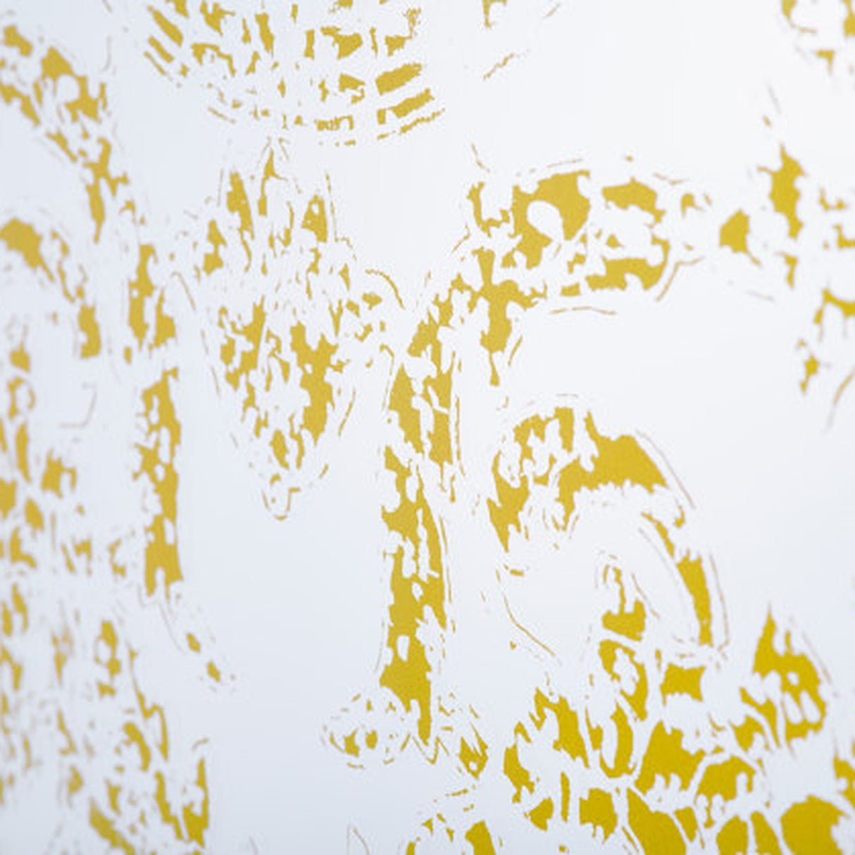 Close-up of the Oxide Bronze Printed Glass Wall Mirror, frameless glass panel with a mottled gold pattern dense at the edges and thinning toward a clear central area.