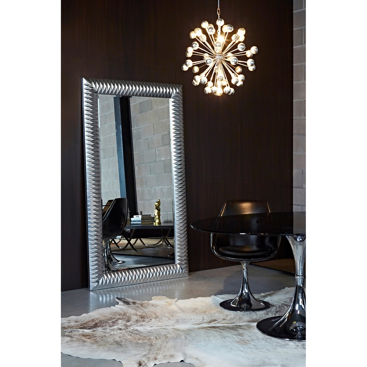 Nick Silver Leaf Full Length Mirror 189cm with faceted silver frame, leaning in a dark-walled room beside a sputnik chandelier and black dining chairs.