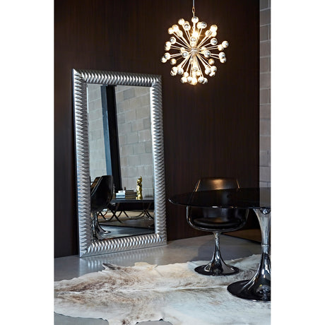 Nick Silver Leaf Full Length Mirror 189cm with faceted silver frame, leaning in a dark-walled room beside a sputnik chandelier and black dining chairs.
