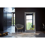 Nick Silver Leaf Full Length Mirror 189cm with faceted silver leaf frame, leaning against a dark wall beside a wire diamond chair in a modern hallway.