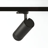 The Solis Three Phase LED Track Spotlight 15W 3000K - Black is a sleek, black cylindrical fixture with a textured base, designed to attach to a ceiling rail and angle downward. This adjustable lighting solution brings modern elegance to any space. The plain white background accentuates its contemporary design.