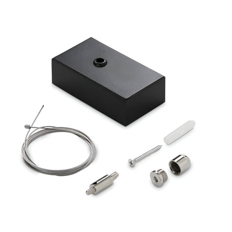 The Ignitia Kit LED Suspension Steel Cable 2m and Black Ceiling Cap is displayed against a white background, featuring a black rectangular ceiling cap with a circular hole on top, accompanied by a coiled steel cable, metal screw, small metal cylinder, two metal components, and an LED suspension piece.