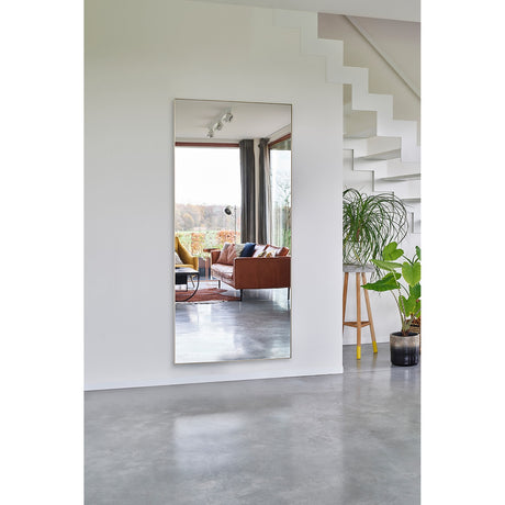Lucka Gold Framed Full Length Mirror, 175cm rectangular wall mirror with slim gold metal frame, shown reflecting a living room with sofa and floor-to-ceiling windows beside a staircase.