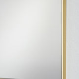 Close-up of the Lucka Gold Framed Full Length Mirror's corner, showing the slim gold metal frame edge against clear glass and a white wall.