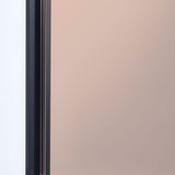 Close-up of the Lucka Bronze Black XXL full length mirror, showing the black metal frame edge against the bronze tinted glass.