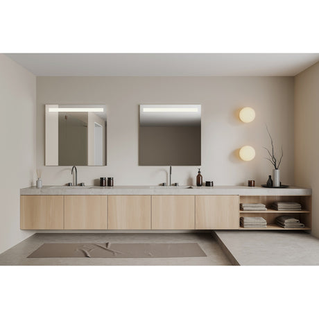 Two square wall mirrors with a backlit horizontal band across the top, mounted above a wooden bathroom vanity with dual sinks.