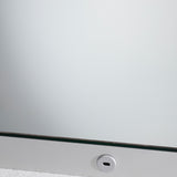 Close-up of the B.Light Backlit LED Square Bathroom Mirror 70cm, showing the glass edge and a round push-button switch set into the metal frame's lower edge.