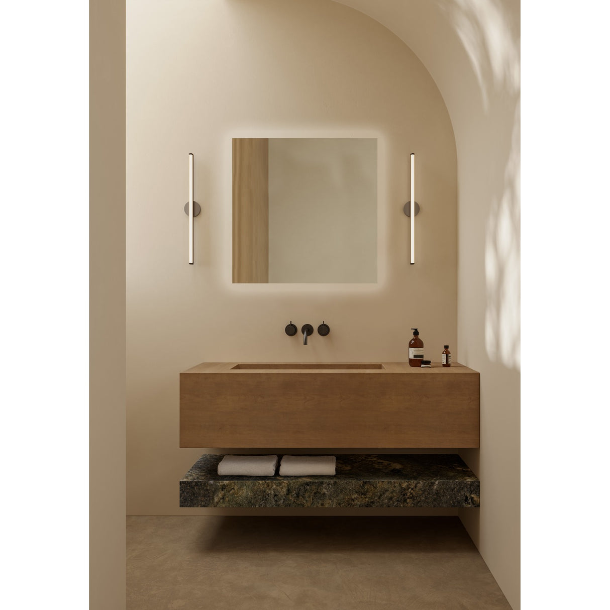 B.Ambi square backlit LED bathroom mirror, 70cm, wall-mounted above a wooden vanity with black wall-mounted taps in a neutral, arched bathroom setting.