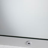 Close-up of the B.Ambi backlit LED square bathroom mirror 70cm, showing the glass edge with a metal frame and a round touch sensor set into the lower border.