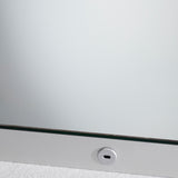 Close-up of the B.Ambi Plus square backlit LED demister bathroom mirror, showing the frameless glass edge and a round touch sensor set into the lower metal frame.
