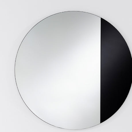 Cord Black Half Tinted Round Wall Mirror 58cm, a frameless circular mirror split vertically into clear glass and black tinted glass, mounted on a plain light wall.