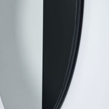 Close-up of the Cord Black Half Tinted Round Wall Mirror 58cm, showing the black frame edge and split between dark tinted glass and clear mirror against a pale wall.