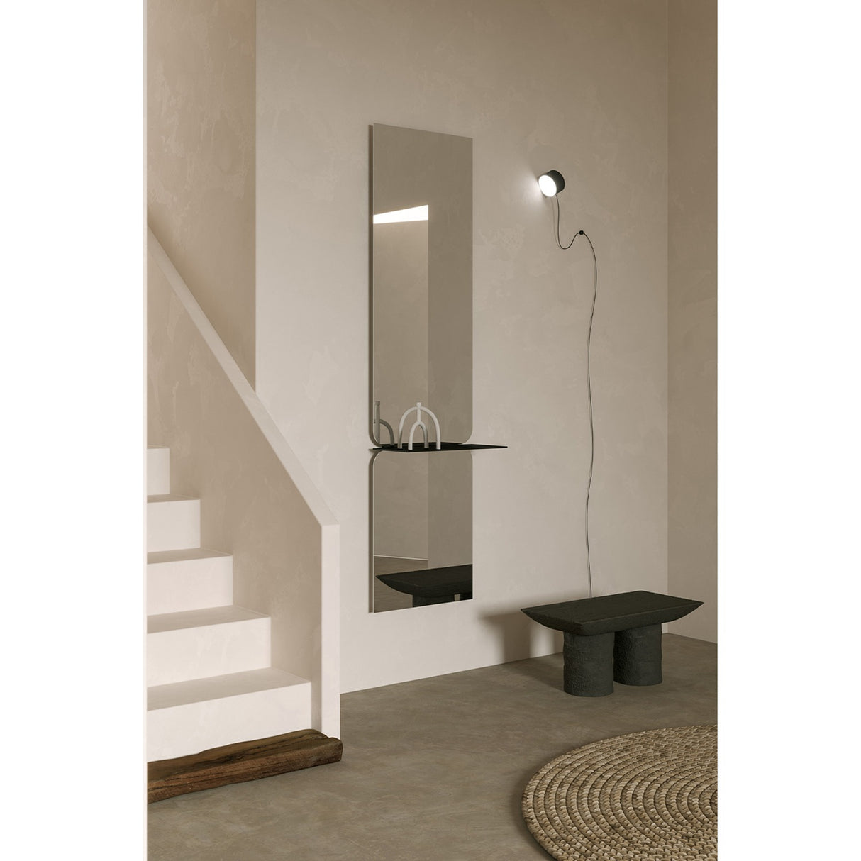 Taille full length hall mirror, 180cm rectangular frameless design in two mirrored panes with a black metal shelf at the join, shown mounted in a hallway near a staircase.