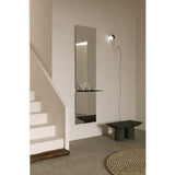 Taille full length hall mirror, 180cm rectangular frameless design in two mirrored panes with a black metal shelf at the join, shown mounted in a hallway near a staircase.
