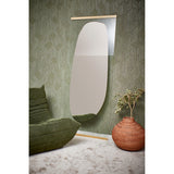 Gold-framed Obu Organic Full Length Leaning Mirror, 178cm, featuring a silvered rock-shaped design, leaning against green wallpaper beside a green sofa and terracotta planter.