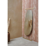 Obu Organic Full Length Leaning Mirror 178cm in gold, with an organic rock-shaped silvered area on clear glass, leaning against a textured pink wall in a decorative room setting.