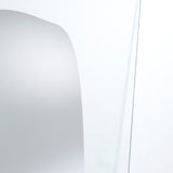 Close-up of the silvered shape meeting the clear glass, the edge of the reflection fading out into transparency.