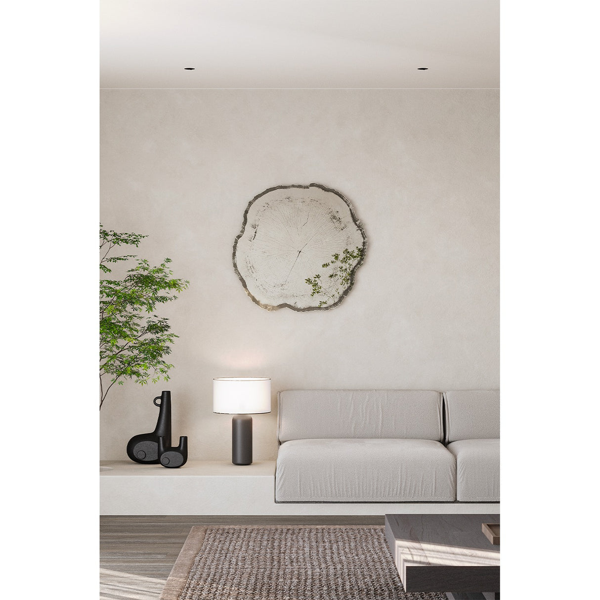 Arbo Dark Tree Ring Printed Glass Wall Mirror 80cm, frameless irregular tree-slice shape with charcoal bark-like edge, shown mounted above a sofa in a neutral living room.
