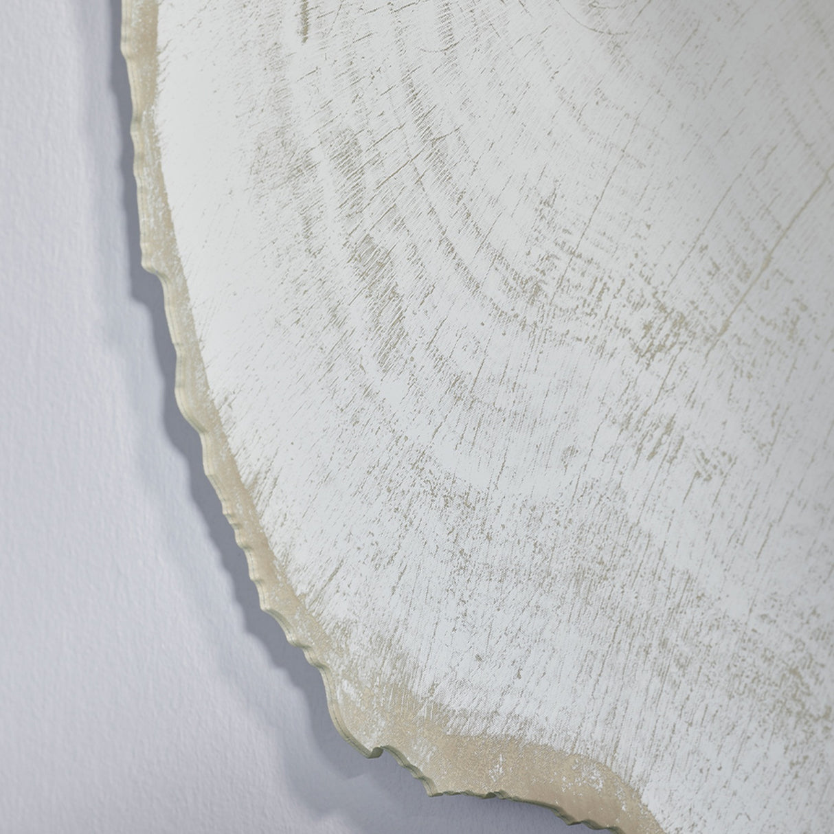 Close-up of the scalloped bark edge where the frosted print stops and the plain wall shows behind the glass.