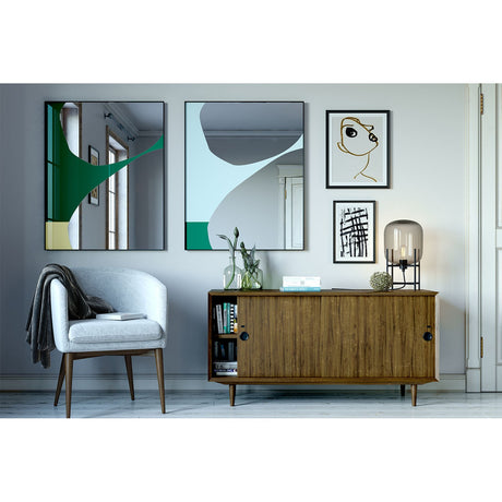 Mika Blue Printed Glass Wall Mirror, rectangular with slim black metal frame, shown in a living room beside a matching green-printed mirror above a wooden sideboard.