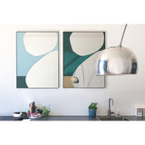 Mika Blue Printed Glass Wall Mirror 107cm in a slim black frame with teal and green curved shapes, shown beside a matching mirror on a kitchen wall.