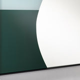 Mika Blue printed glass wall mirror in a slim black metal frame, close-up of curved teal and green shapes on the lower reflective surface.
