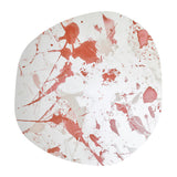 Floc Paint Splatter Printed Glass Wall Mirror, 105cm, frameless irregular shape with red splatter print across the silvered glass, shown on a plain white background.