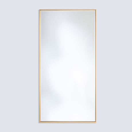 Soho Gold Slim Framed Full Length Mirror, rectangular with a narrow flat gold frame, mounted on a plain light grey wall.
