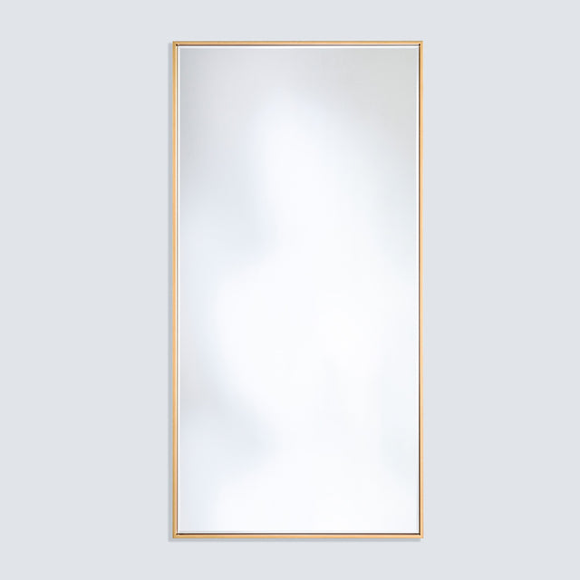 Soho Gold Slim Framed Full Length Mirror, rectangular with a narrow flat gold frame, mounted on a plain light grey wall.