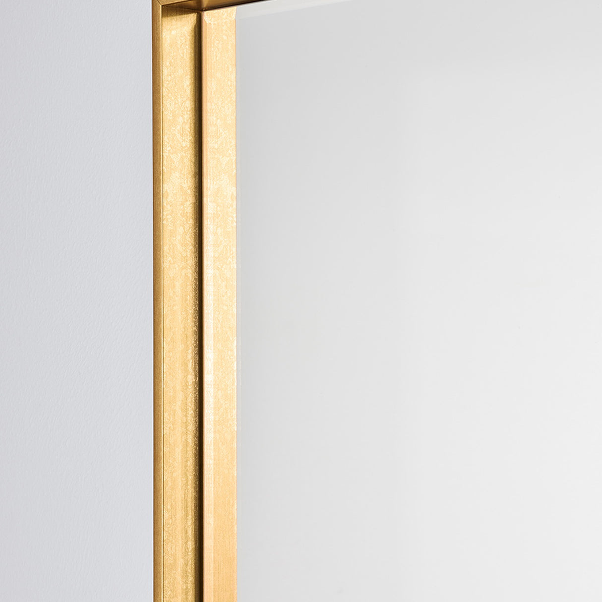 Close-up of the Soho Gold Slim Framed Full Length Mirror, showing the narrow rectangular gold frame's squared edge against a plain light background.
