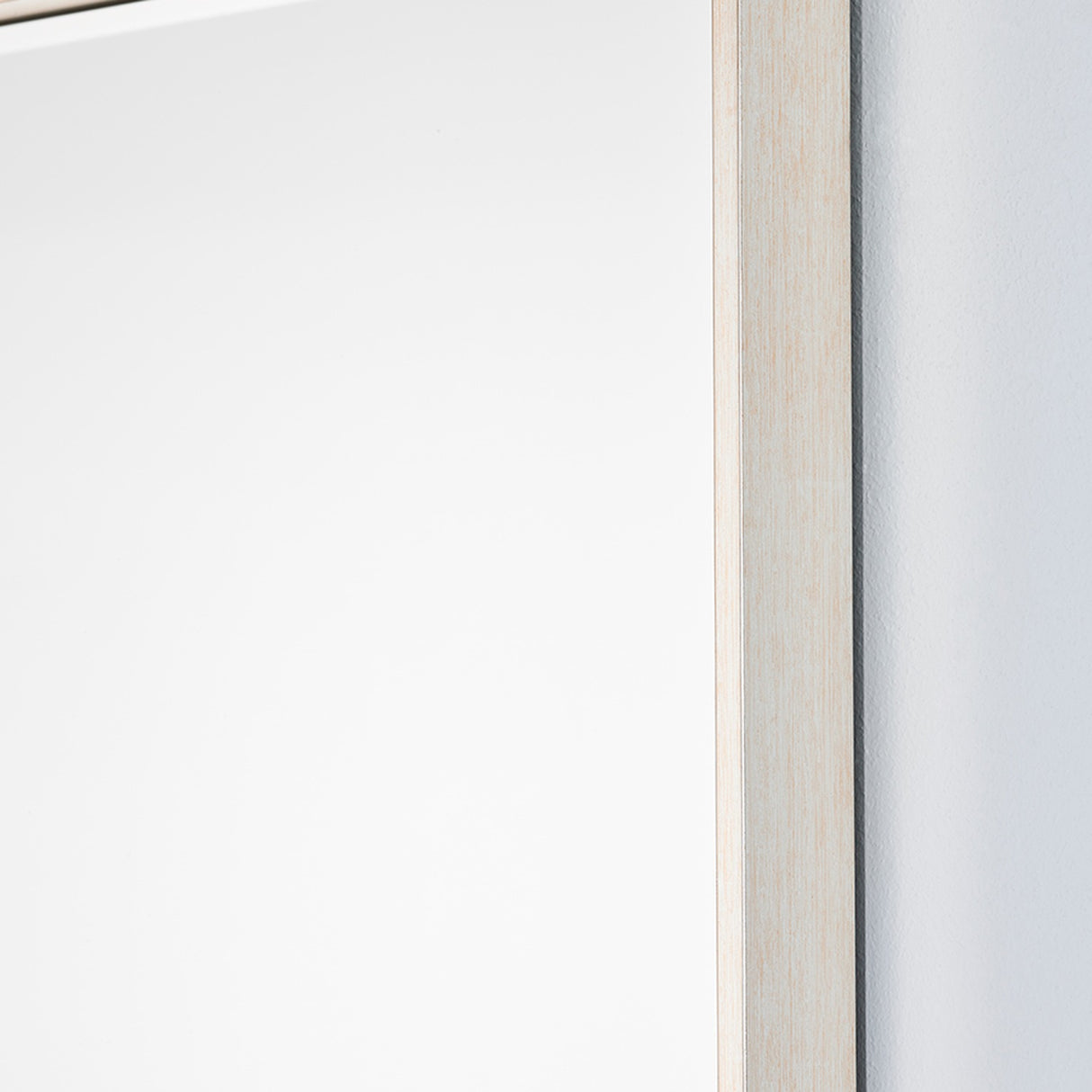 Close-up of the Soho Silver Slim Framed Full Length Mirror, showing the narrow, squared-off pale silver frame edge against a plain light wall.