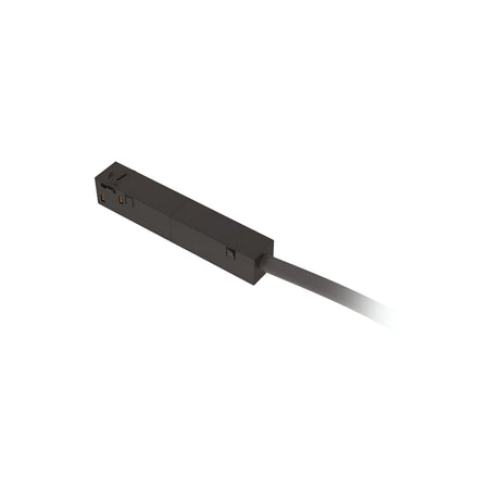A close-up of a Luxeon Dimmable Main Power Connector - Black highlights its sleek rectangular design featuring smooth surfaces with subtle grooves and markings. Extending out of view on the right side is a power connection cable, indicating its essential function in seamlessly integrating magnetic track lighting systems.