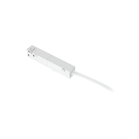A stylish Luxeon Dimmable Main Power Connector in white, featuring a rectangular body with a slender cable protruding from one end. Its smooth surface has subtle grooves, giving it the appearance of a contemporary electronic accessory reminiscent of modern magnetic track lighting designs. The background is plain white.