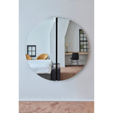 Luna Black Two Piece Round Wall Mirror 150cm reflecting a bedroom and desk area, its frameless glass split by a central black lacquered strip.