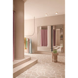 Luna Black Two Piece Square Wall Mirror 200cm, frameless glass panes with a black lacquered vertical divide, shown reflecting a pink-toned changing room with curtains and stone flooring.