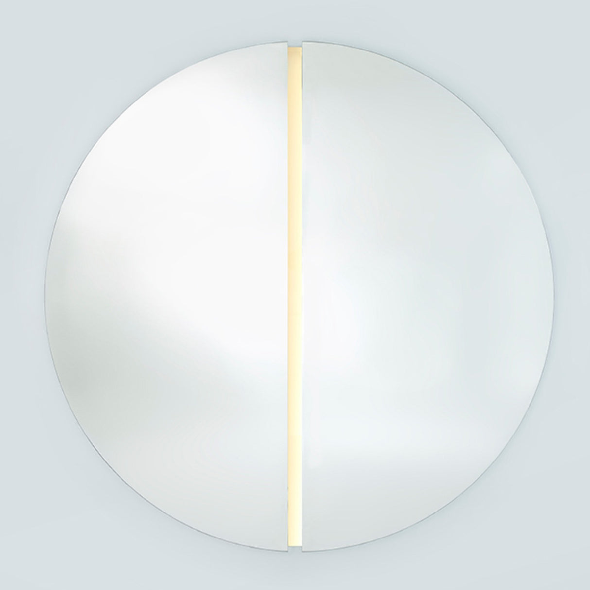 The lit round mirror seen larger, the strip running the full height of the channel that separates the halves.