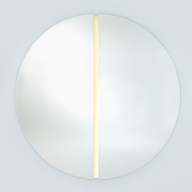 The lit round mirror seen larger, the strip running the full height of the channel that separates the halves.