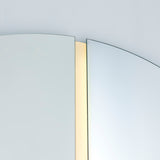 Close-up of the lit joint, the warm LED strip set deep into the channel between the two half moons.