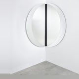 Luna Black Two Piece Corner Wall Mirror 150cm, a round frameless mirror split into two halves mounted across a room corner with a black lacquered glass strip at the join.