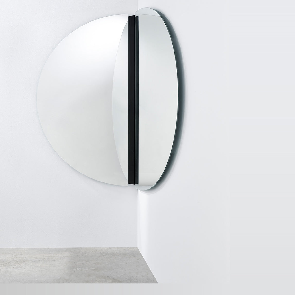 Luna Black Two Piece Corner Wall Mirror 150cm, a round frameless glass mirror split into two halves mounted at a corner angle, joined by a black lacquered strip.