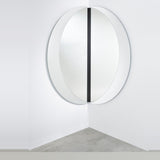 Luna Black Two Piece Corner Wall Mirror 200cm, a round frameless mirror split into two curved panels mounted at right angles with a black lacquered glass strip at the corner join.
