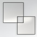 Quadro Overlapping Squares Printed Glass Wall Mirror 105cm, a frameless square design with two overlapping outlined squares in black, one transparent where they cross, on a plain light grey wall.