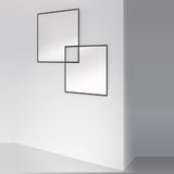 Quadro Overlapping Squares Printed Glass Wall Mirror 105cm, two frameless square mirrors with black outlined edges overlapping on a white wall.