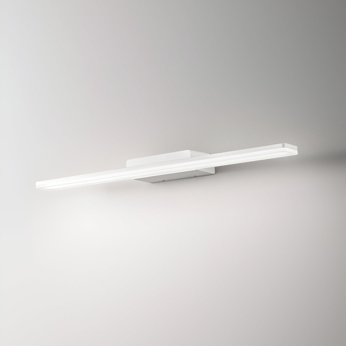 The Orbix LED Bathroom Mirror Light 18W, with its sleek and modern design, is crafted from powder-coated aluminum to enhance a minimalist aesthetic. Mounted on a white wall, its elongated shape provides a soft and uniform glow, creating an elegant and contemporary ambiance. This energy-efficient LED light offers both style and sustainability.