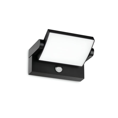 The Solstice LED Outdoor Motion Sensor Wall Light 21W 3000K in black, with a modern square design, is mounted on a white wall. This fixture offers a sleek appearance with its durable aluminum body and includes a central sensor positioned below the adjustable diffuser.