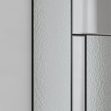 Close-up of the Finestra Deco full length mirror in black, showing slim metal grid bars framing reeded textured glass panels against a plain light grey wall.