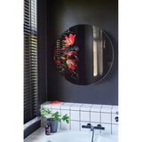 Museo Still Life Printed Round Wall Mirror, 100cm frameless circular mirror with a printed floral still life fragment on one side, shown mounted on a dark bathroom wall above a tiled tub.
