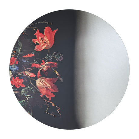 Round wall mirror carrying a printed fragment of a still life, red tulips and irises on a dark ground.