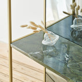 Chassis XL Deluxe free standing mirror detail showing gold metal frame and green marble shelf with a glass bud vase and dried pampas grass stems.