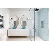 Two oval frameless wall mirrors above a bathroom vanity with teal vessel sinks, hung from black wall fittings against white walls and blue tiled shower.